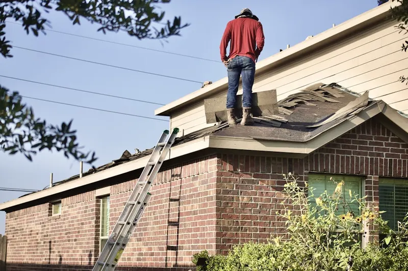 Professional roofer working on a residential roof in Kingwood Forest